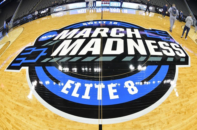 The March Madness logo at the center of the court at Sprint Center in Kansas City.
