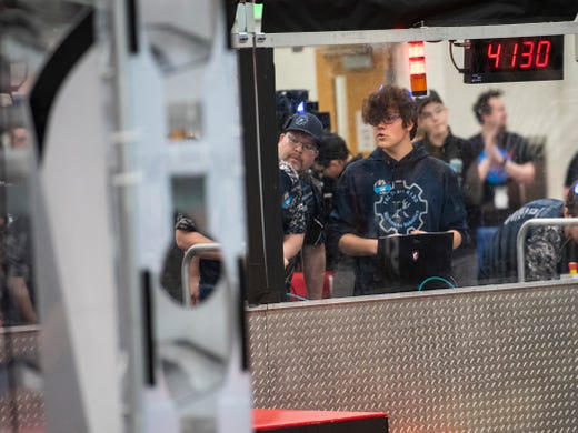 Luke Evans, right, Richmond Blue Devils driver and electrical captain, commands his team's robot during the FIRST Robotics district event Friday, March 29, 2019 at Marysville High School. This year, the Blue Devils designed their robot to be balanced, so that they could coordinate play to complement their alliance partners.