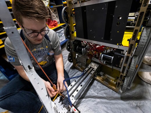 Algonac High School junior Eddy Boughner, 16, works to make the winch on his team's robot return to its position automatically before competing in the FIRST Robotics district event Friday, March 29, 2019 at Marysville High School.
