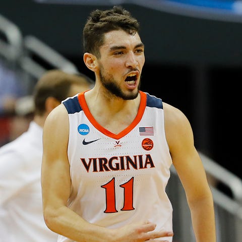 Ty Jerome #11 of the Virginia Cavaliers reacts...