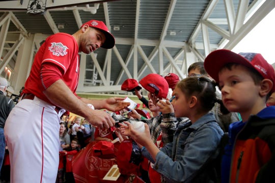 Cincinnati Reds first baseman Joey Votto (19) walks the red carpet during Kids Opening Day before an MLB baseball game against the Pittsburgh Pirates, Saturday, March 30, 2019, at Great American Ball Park in Cincinnati. Votto is one of five players signed for 2020.