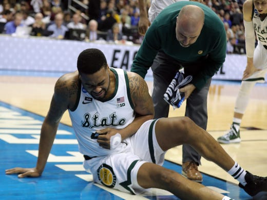 Michigan State forward Nick Ward goes down hurt during the second half of the 80-63 win over LSU in the NCAA tournament on Friday, March 29, 2019, in Washington.