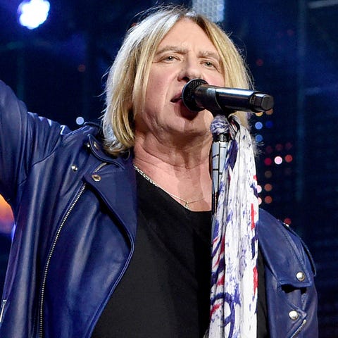 Def Leppard's Joe Elliott, left, performs with...