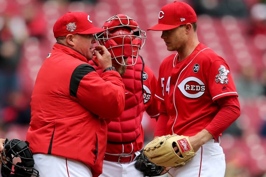 Cincinnati Reds throwing coach, 36-year-old Derek Johnson, talks to 54-year-old pitcher Sonny Gray on the mound in MLB's second run against Pittsburgh Pirates on Sunday, March 31, 2019 at the Great American Ball Park in Cincinnati.