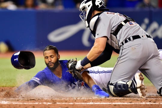 Toronto Blue Jays shortstop Richard Urena is tagged out at home plate by Detroit Tigers catcher Grayson Greiner on a run-saving play by Jordy Mercer in the 10th inning.