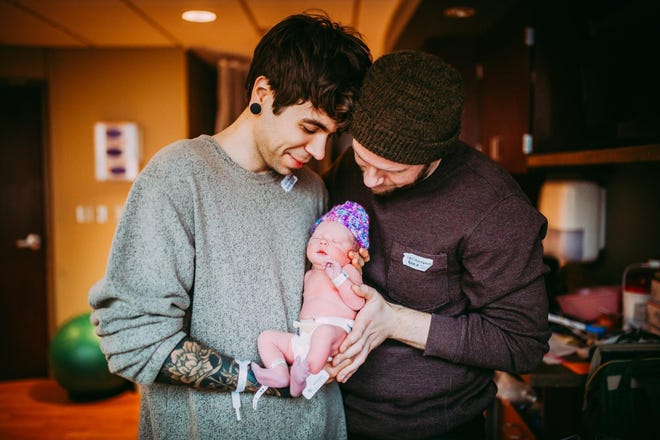 Elliot Dougherty and Matthew Eledge hold their new daughter, Uma Louise.