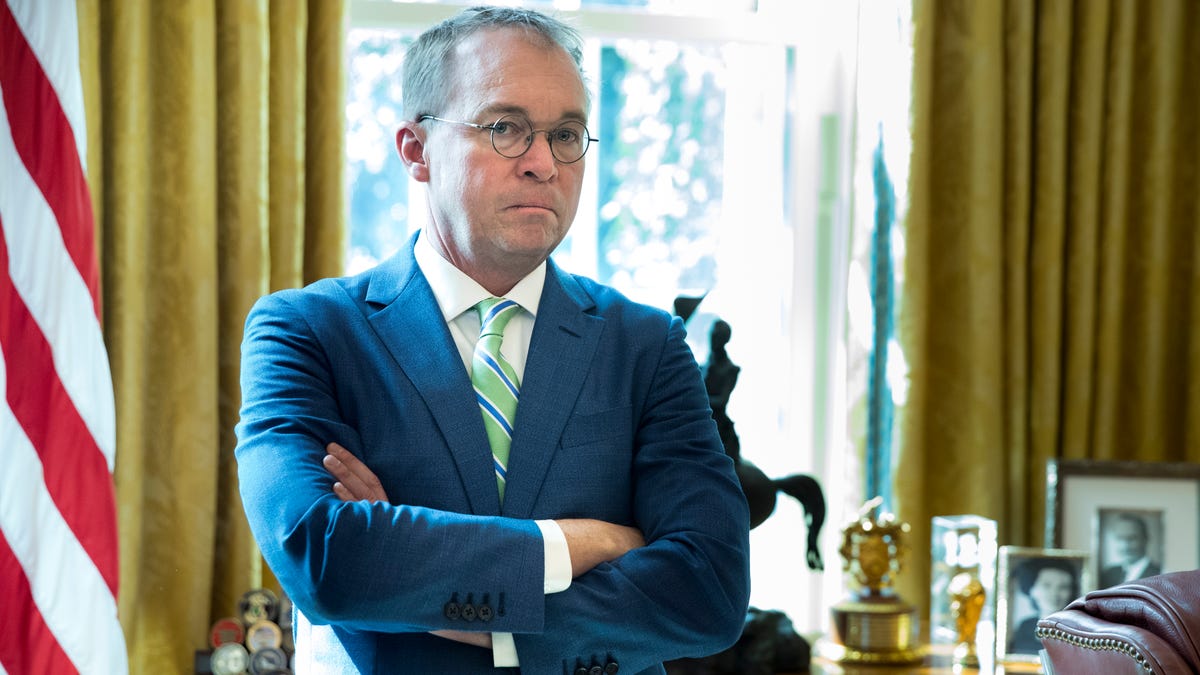 Acting White House Chief of Staff Mick Mulvaney stands by the Resolute desk in the Oval Office of the White House in Washington, March 27, 2019.