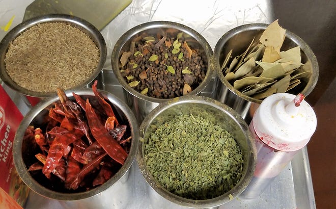 Whole fresh spices such as cumin, a masala mix, bay leaves, chiles and fenugreek leaves ready to be added to dishes at Royal India Cuisine in Newburgh.