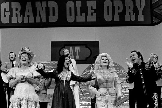 Minnie Pearl, left, Loretta Lynn, Dolly Parton and Roy Clark are finishes a song together during the end of taping "The Grand Ole Opry at 50, A Nashville Celebration" for a nationally televised special at Opry House Oct. 23, 1975. Ryman Hospitality has a trove of footage from shows performed from the Opry, which could be included in its new television project.