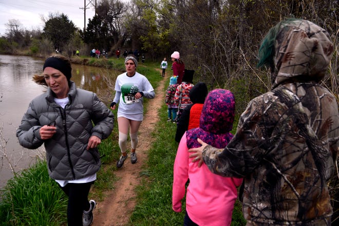 Hikers and some who wished to jog the annual Mayor's Hike pass each other along Cedar Creek Saturday. Water was flowing in the creek, Randy Barnett of the Cedar Creek Waterway said they turn on the effluent water for the hike, which drains into Lake Fort Phantom Hill.
