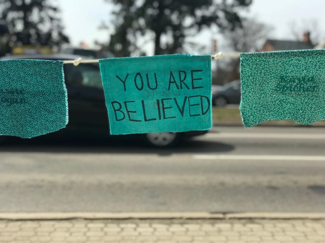 Teal prayer flags with messages of support for sexual assault survivors line Grand River Avenue. Once all the flags are up, there will be one for each of the 505 known survivors of former MSU sports doctor Larry Nassar's sexual abuse.