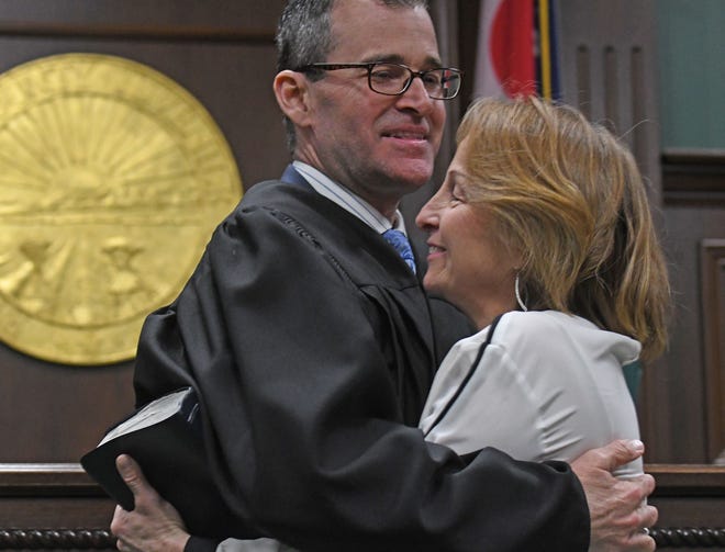 Steve McKinley hugs his wife Ann on Tuesday after we was sworn in as Richland County juvenile court judge.