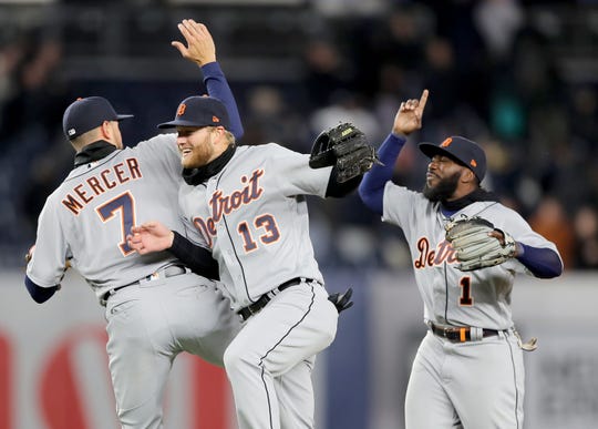 Jordy Mercer # 7, Dustin Peterson # 13 and Josh Harrison # 1 of the Detroit Tigers celebrate the 3-1 win against the New York Yankees at Yankee Stadium on April 2, 2019 in the Bronx in New York.