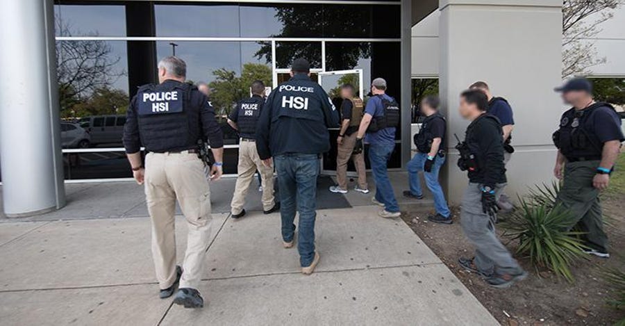 ICE agents enter a business in Allen, Texas, on April 3, 2019.