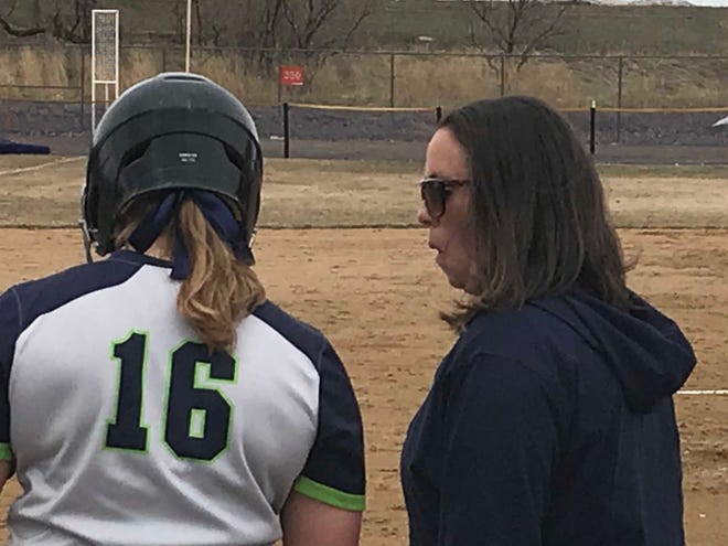 Providence head softball coach Joey Egan talks with infielder Hanna Tarum (16) between innings during their league game with Northwest University Friday at Multi-Sports Complex.