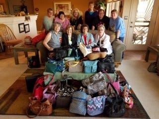 Members of the Omega Chapter of Delta Kappa Gamma filled 57 purses with toiletries,essentials and cosmetics for homeless women of the City of Hope April 1.