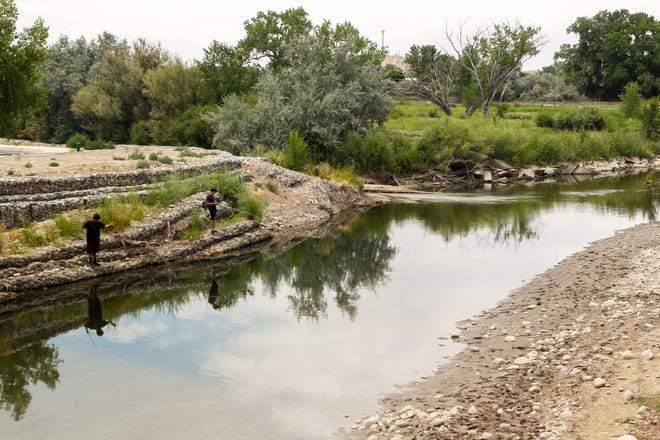 The City of Aztec may partner with San Juan Soil and Water Conservation District, Basin Hydrology and Cottonwood Consulting to remove concrete blocks and junk from the Animas River in Riverside Park and in Rio de Animas Park. In this 2018 file photo, a group fishes in the river at Riverside Park in Aztec.