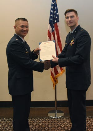 2nd Lt. Jordan Weum, 315th Training Squadron student, is presented with The Air Force Commendation Medal at his technical school graduation by Lt. Col. Mark Chang, 315th TRS commander at the Event Center on Goodfellow Air Force Base, Texas, April 4, 2019. The Air Force Commendation Medal is a military decoration which is presented to an individual who demonstrates courage.