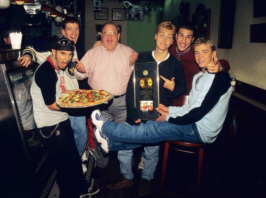 Boy-band creator Lou Perlman died in 2016 in prison while serving a 25-year sentence for a Ponzi scheme. He's shown here in 1996 with NSYNC's Chris Kirkpatrick, JC Chasez, Lance Bass, Joey Fatone and Justin Timberlake.