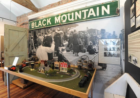 A display on the second floor gallery of the Swannanoa Valley Museum and History Center features an old metal sign that used to hang at the Black Mountain depot and an enlarged photograph of a scene from the early days of the railroad hub.