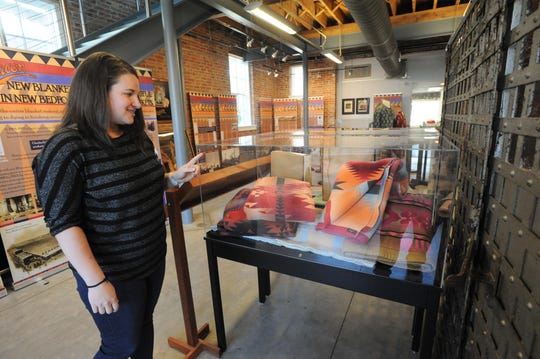 Swannanoa Valley Museum and History Center director Anne Chesky Smith talks about a display featuring blankets from Beacon Manufacturing, which is the focus of the museum's major exhibit this season. SVM will open its doors for the 30th year on April 13.