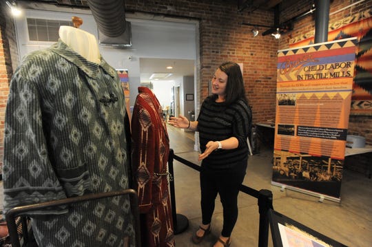Anne Chesky Smith, director of the Swannanoa Valley Museum and History Center, offers a glimpse of the Beacon Manufacturing exhibit in the first floor gallery of the museum, which will open for the season on April 13.