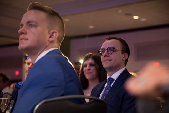 Chasten Buttigieg, right, listens as his husband, Democratic presidential candidate Pete Buttigieg, speaks at the LGBTQ Victory Fund National Champagne Brunch on April 7, 2019 in Washington.