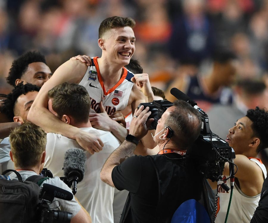 Virginia guard Kyle Guy celebrates the win over Auburn with teammates.