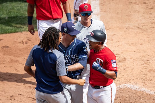 Eduardo Escobar #5 of the Minnesota Twins is separated from Chris Archer #22 of the Tampa Bay Rays on July 15, 2018 at Target Field in Minneapolis, Minnesota. The Twins defeated the Rays 11-7.