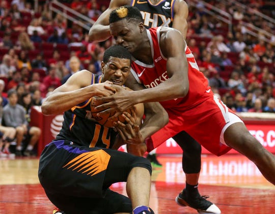 Apr 7, 2019; Houston, TX, USA; Phoenix Suns guard De'Anthony Melton (14) and Houston Rockets center Clint Capela (15) battle for the ball during the second quarter at Toyota Center. Mandatory Credit: Troy Taormina-USA TODAY Sports