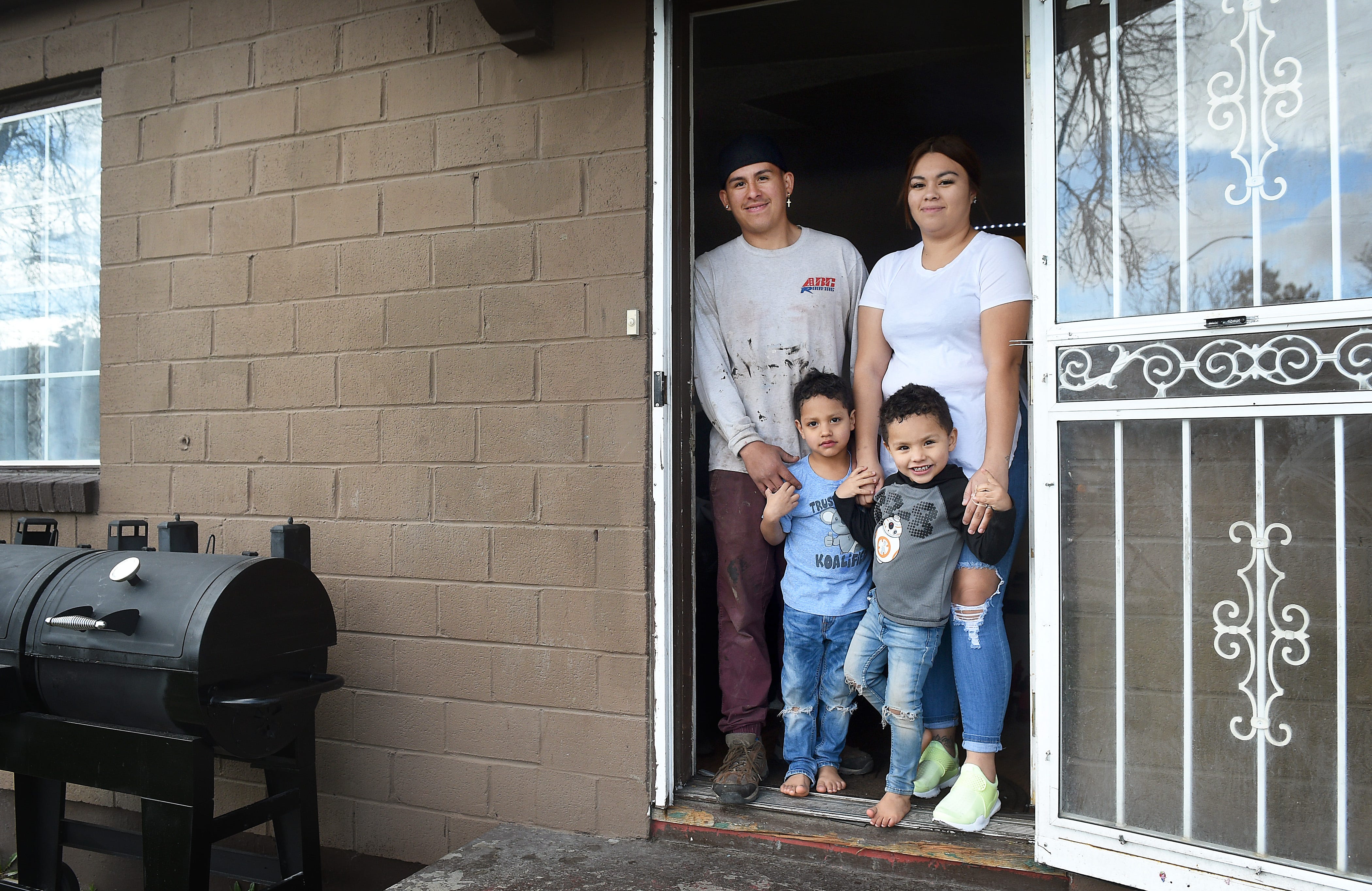 Beatriz Asencio, her husband Josue Navarro, and their two children Miguel, left, and Didier pose for a portrait at their home on A Street in Sparks on April 2, 2019.