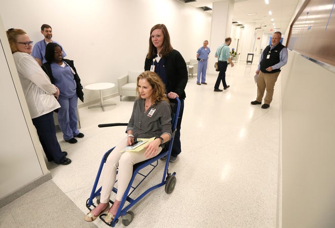 Brianna Jackson pushes Jennifer Dorman through the halls of Shorb Tower as they conduct a mock medical exercise at Methodist University Hospital's new addition on Tuesday preparing for the opening of the facility later this month.