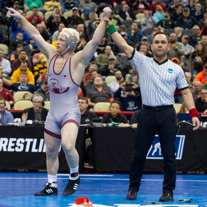 Lock Haven's Chance Marsteller has his hand raised in victory after winning the third-place match at the 2019 NCAA Division I Wrestling Championships in Pittsburgh.