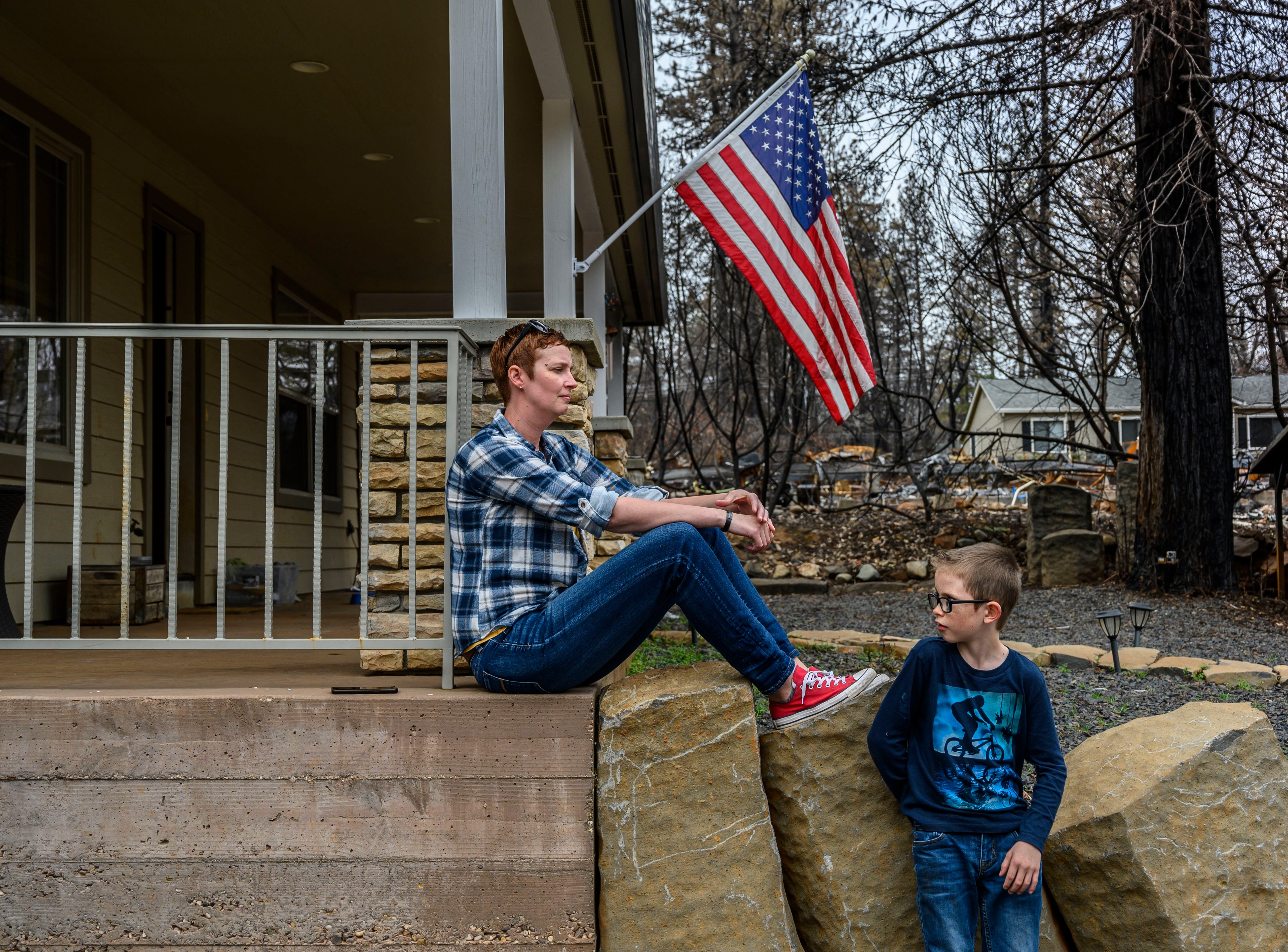 Dawn Herr and her son Liam, 8, visit their home on Tuesday, March 19, 2019 in Paradise that survived the Camp Fire. 