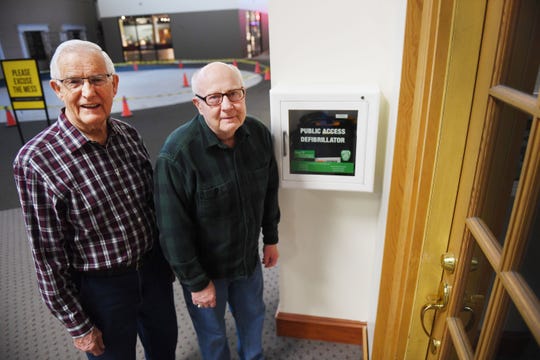 Ray Smidt and Bill Winness stand by the AED, Automated External Defibrillator, they used to save their friend Keith Clark Tuesday, April 9, at the Western Mall in Sioux Falls. Smidt and Winness' friend Keith, 81, suffered a heart attack last week during their normal walking route at the mall.