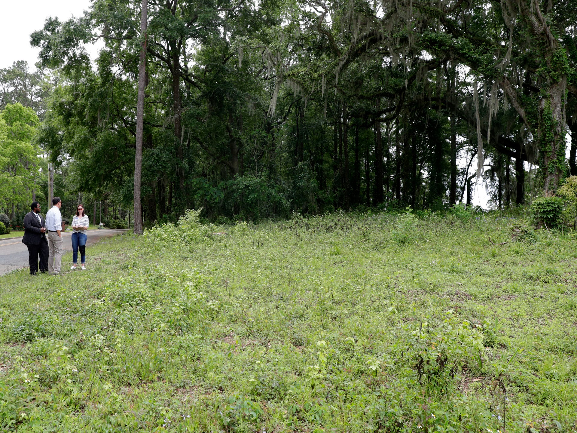 Activist Delaitre Hollinger, left, Jonathan Lammers, a historical preservation consultant, and Barbara Clark, the historian for the Capital City Country club, discuss the location of a burial site is believed to be at the Capital City Country Club Tuesday, April 9, 2019.