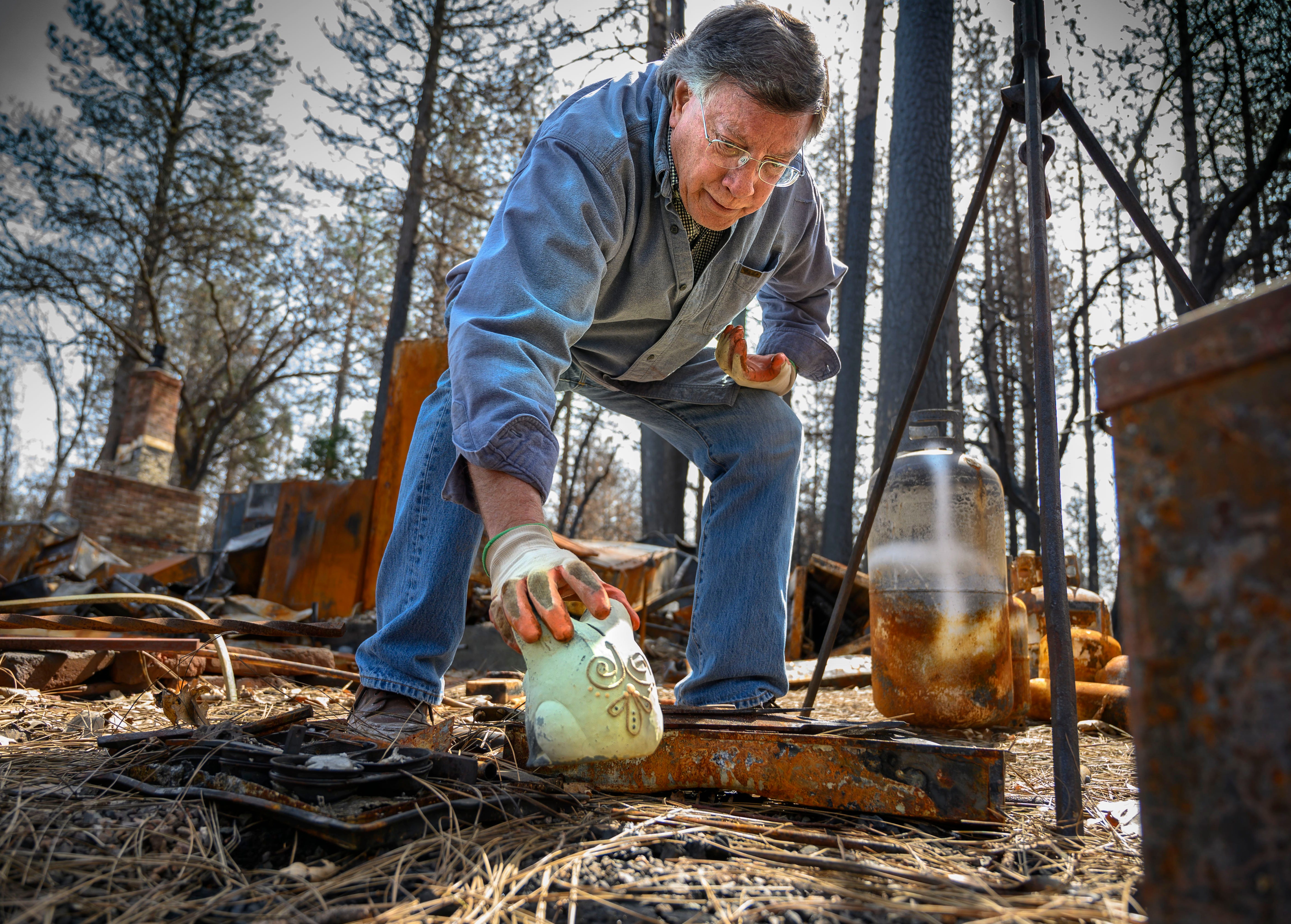 Gene Mapa collects metal and ceramic objects that didn't burn in the Camp Fire at his house in Paradise. Mapa now lives in Colfax, which as a similar level of fire risk.
