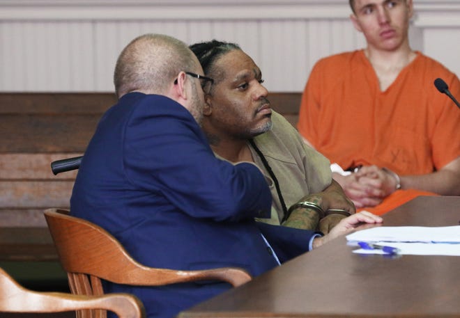 Gerald Draughn consults with his attorney Keith Edwards during his hearing Wednesday. Draughn pleaded guilty to 13 counts of drug trafficking and possession.