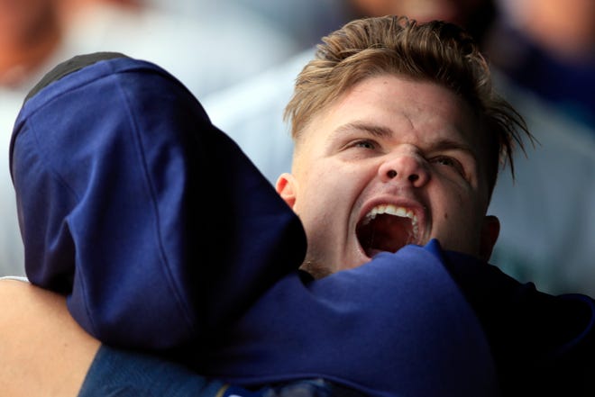 Seattle Mariners designated hitter Daniel Vogelbach hugs a teammate while celebrating in the dugout after hitting a solo home run during the 10th inning of a baseball game against the Kansas City Royals at Kauffman Stadium in Kansas City, Mo., Thursday, April 11, 2019. The Mariners defeated the Royals 7-6 in 10 innings.