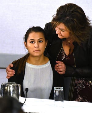 Michigan State University student Bailey Kowalski gets support from her mother, Robin Kowalski, before an April press conference in East Lansing.