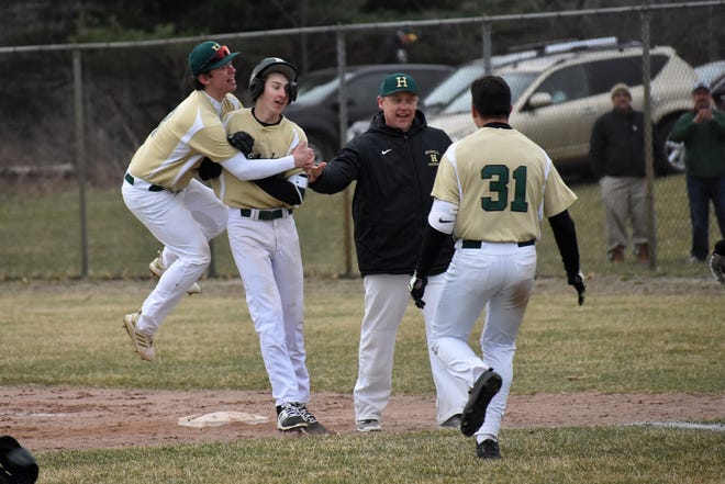 Nick Austin hugs Howell teammate Adam Mrakitsch after Mrakitsch hit a game-winning single in the eighth inning against Brighton on Wednesday, April 10, 2019.