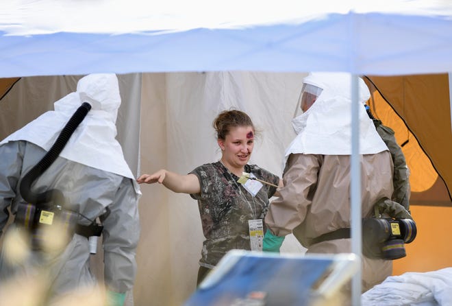 Sadie Peters, 18, a junior at St. Lucie West Centennial High School, plays the part of a victim going through decontamination and being treated by the Hospital Emergency Response Team, (HERT), at the Cleveland Clinic Tradition Hospital in Port St. Lucie on Thursday, April 11, 2019, during full-scale disaster preparedness exercises. "It helps to save a life," Peters said. More than 150 high school students are participating, playing the roll of victims, during the exercise. Cleveland Clinic Martin Health hospitals, along with the Central Florida Disaster Medical Coalition, are participating in the exercises.