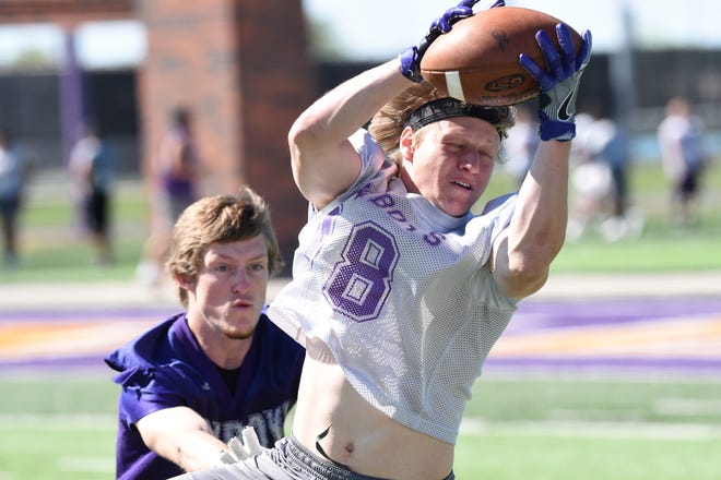 Hardin-Simmons receiver Cale Nanny (18) hauls in a pass during spring practice.