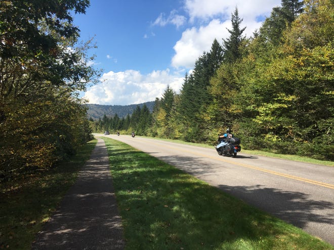 A motorcycle cruises the Blue Ridge Parkway last year in the Devils Courthouse area.