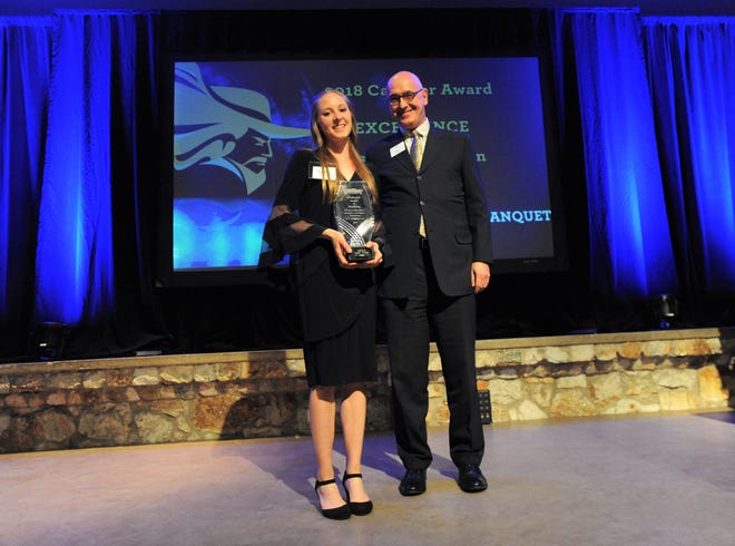 Four-time All-American runner Lydia Wilson receives the 2018 Cavalier Award of Excellence from Montreat College president Paul Maurer in the Upper Anderson Auditorium on April 12.