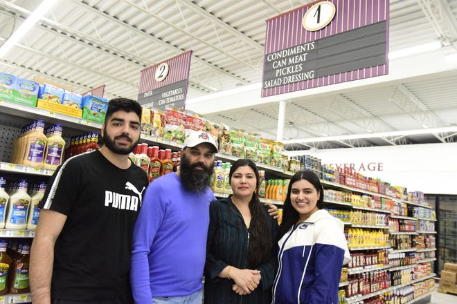 The KV Market at 359 W. Fourth St. is scheduled to open Thursday. Owners and family members are, from left, Dalip Singh Bhullar, Karamjit Singh Bhullar, Varinder Kaur Bhullar and Avneet Kaur Bhullar.