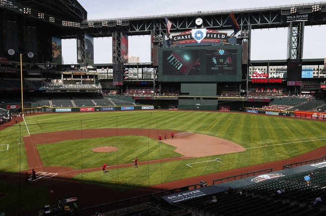 New artificial turf has been installed at Chase Field this season as grounds crew workers to prepare for a spring training game between the Arizona Diamondbacks and the Milwaukee Brewers  March 26, 2019.