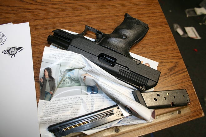 A handgun and ammunition recovered inside Marinette High School after the hostage taking incident on November 29, 2010. Provided by Marinette Police Department