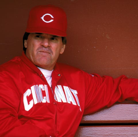 Then-Reds Manager Pete Rose sits in the dugout dur
