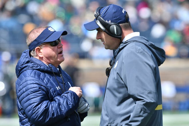 Apr 13, 2019; Notre Dame, IN, USA; Notre Dame Fighting Irish head coach Brian Kelly talks with Defensive line coach Mike Elston in the third quarter of the Blue-Gold Game at Notre Dame Stadium. Mandatory Credit: Matt Cashore-USA TODAY Sports